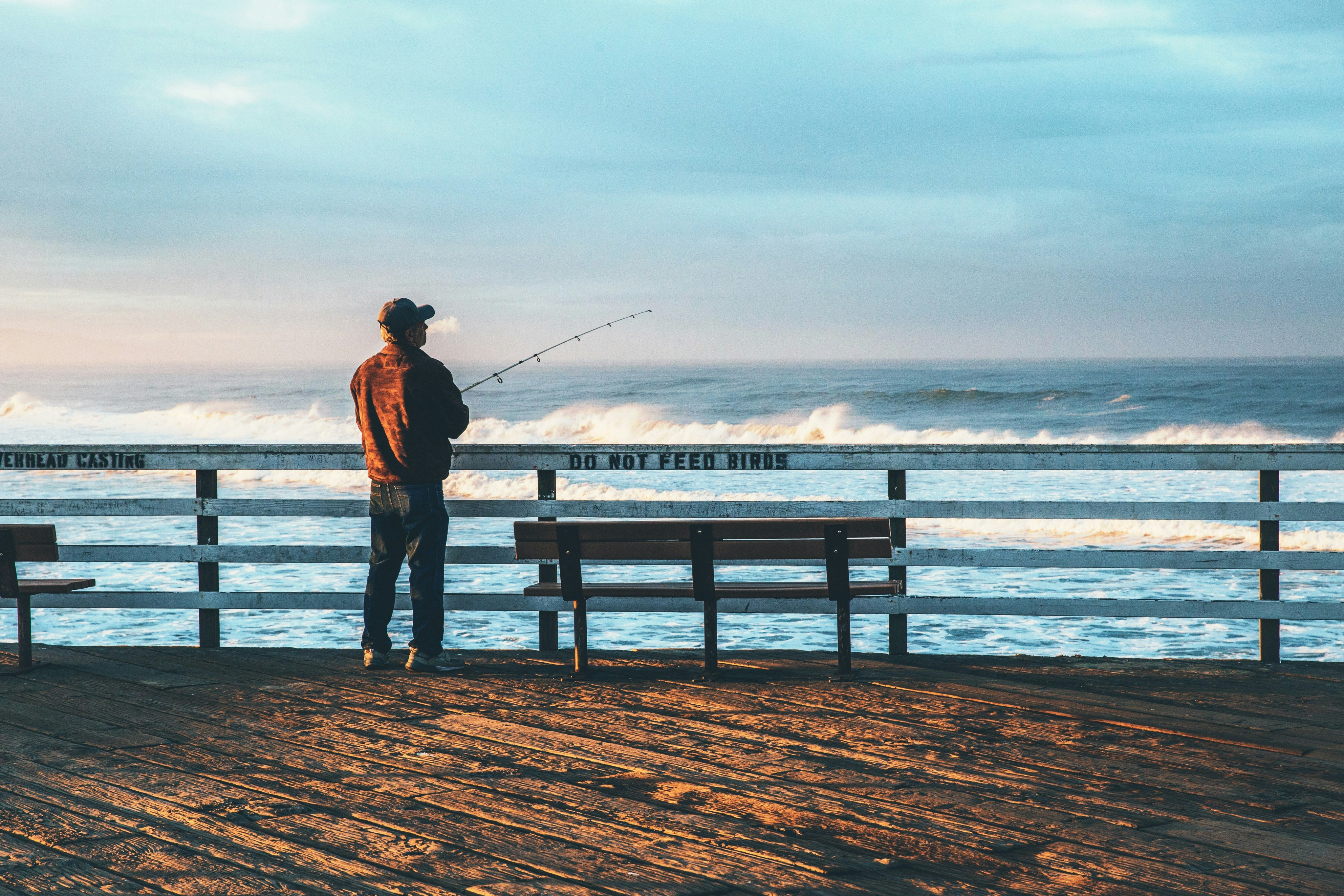 man fishing on seaside